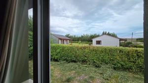 a view of a house from a window at Cabañas El Amanecer in El Calafate
