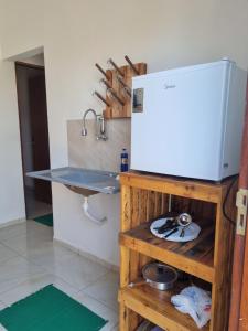 a kitchen with a counter and a sink and a counter at Pousada Aconchego Vitória in Parnaíba +7 photos