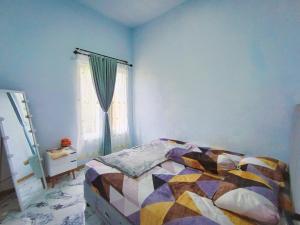 a bedroom with a bed and a window at Villa Kanaya in Sukapura