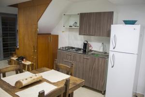 a kitchen with a table and a white refrigerator at La Palma Paradise 1 in Medellín