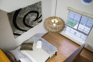 a small room with a bed and a window at La Palma Paradise 1 in Medellín +3 photos