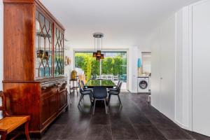 a dining room with a table and chairs at Lisbon Casa da Clementina - a Serene Garden Stay in Lisbon