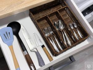 a drawer filled with silver utensils on a counter at RentHouse Apartments-Old Town Studio #2 in Chişinău +15 photos