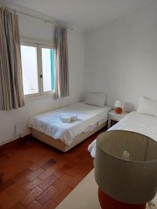 a room with two beds and a chair in it at Ocean Villa Algarve in Alvor +62 photos