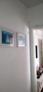 a room with two pictures on the wall at Apto com charme conforto vista e completo in Florianópolis