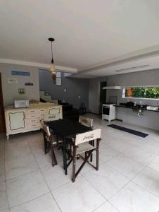 a kitchen with a table and chairs in a room at Casa da Amandinha in Florianópolis