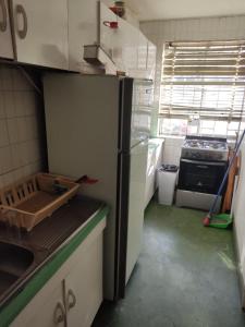 a kitchen with a refrigerator and a stove in it at Departamento Copacabana in Viña del Mar