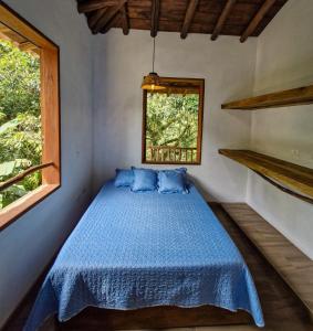 a bed in a room with a window at Caminos Alojamiento in Jardin