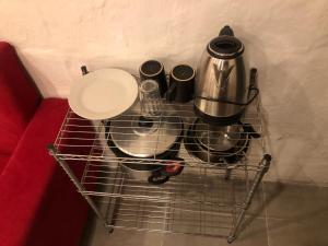 a shopping cart with pots and pans and a coffee maker at Rancho aparte in Barra de Valizas