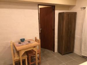 a room with a wooden table and a door at Rancho aparte in Barra de Valizas