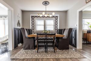 a dining room with a table and chairs at The Little Blue Bungalow - Walk to Shops & Eats in Perrysburg