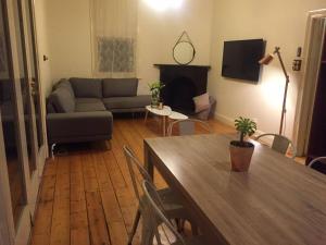 a living room with a couch and a table at Myers CBD in Bendigo