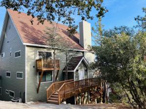 a home with a deck and a house at Modern 6 bedroom retreat, stunning lake views, close to village! in Lake Arrowhead