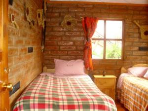 Postel nebo postele na pokoji v ubytování Hostal Rumyhuasy