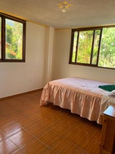 Postel nebo postele na pokoji v ubytování Hostal Rumyhuasy