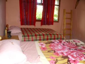 Postel nebo postele na pokoji v ubytování Hostal Rumyhuasy