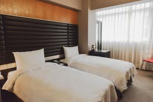 Postel nebo postele na pokoji v ubytování 新麗旅店 Newful Hotel