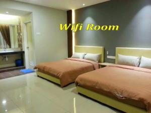말라카 호텔 아파트먼트 객실 침대