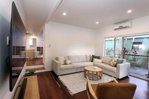 a living room with a couch and a table at 6 Dooley Street Bargara in Bargara