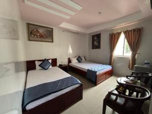 Kama o mga kama sa kuwarto sa Thành Đạt Hotel Bạc Liêu