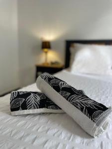 a pair of towels sitting on a bed at Le Colibris du Lamentin in Lamentin