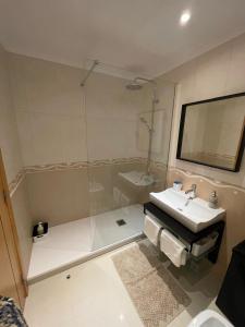 a bathroom with a sink and a glass shower at Quinta dos Lombos in Carcavelos +16 photos