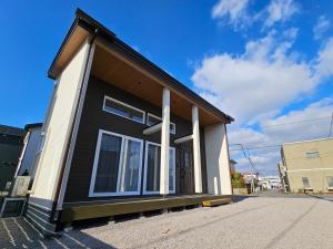 a house with a black and white at Onasyas-A in Hakodate