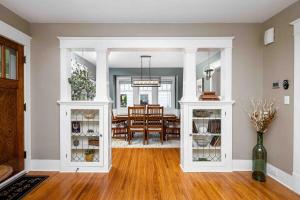 a living room with white cabinets and a dining room at The Craftsman Uptown - Walk to Shops & Eats in Perrysburg