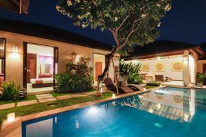 a swimming pool in the backyard of a house at Samana Villas in Legian