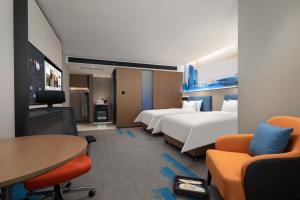 מיטה או מיטות בחדר ב-Hampton by Hilton Changsha Wuyi Square