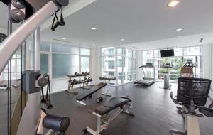 a gym with treadmills and machines in a building at Modern 2-Bedroom Condo in Kamala Near the beach in Kamala Beach