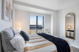 a bedroom with a large bed and a large window at Newtown Tranquility Spacious 2-Bedroom Apartment in Wellington