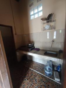 a small kitchen with a counter and a sink at Villa Bidadari in Ciater