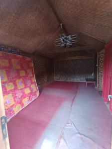 a room with a pink mattress and a ceiling at Villa Bidadari in Ciater