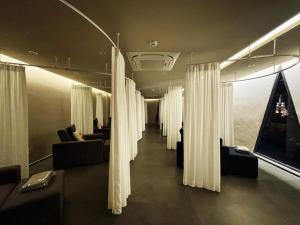 a hallway with curtains and couches in a room at 사이공 트래블 라운지 Saigon Travel Lounge in Ho Chi Minh City