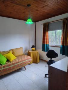 a living room with a couch and a table at Tinkunaco Alta Gracia in Alta Gracia +15 photos