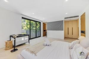 a bedroom with a large white bed and a desk at Harbour view new year firework in Sydney +27 photos