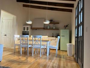 a kitchen with a table and chairs and a refrigerator at Penthouse Santorino en Valquirico in Santeagueda
