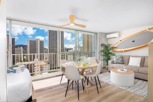 a living room with a table and a large window at Stylish Studio with Great Ocean Views & Near Beach! in Honolulu
