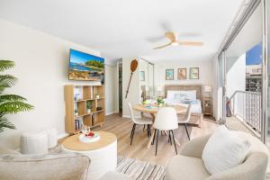 a living room with a table and a dining room at Stylish Studio with Great Ocean Views & Near Beach! in Honolulu