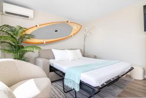 a room with a bed and a chair and a mirror at Stylish Studio with Great Ocean Views & Near Beach! in Honolulu