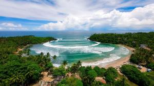 an aerial view of a beach in the ocean at Thaproo Bay Hiriketiya in Dickwella