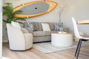 a living room with a couch and a table at Stylish Studio with Great Ocean Views & Near Beach! in Honolulu