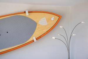 a cutting board on a wall next to a plant at Stylish Studio with Great Ocean Views & Near Beach! in Honolulu