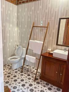 a bathroom with a toilet and a sink at An Yen Resort in Phú Quốc +37 photos