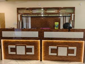 a counter in a room with two brown at MOUNT OASIS RESIDENCY Tiruvannamalai in Tiruvannāmalai