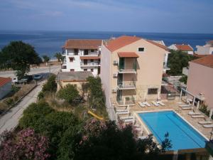 a view of a building and a swimming pool at Petros Studios in Póros Kefalonias