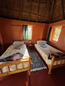 Voodi või voodid majutusasutuse Malealea Lodge toas