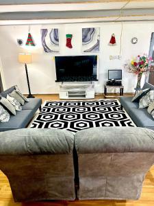 a living room with a couch and a television at Melissa cosy corner in Tafuna