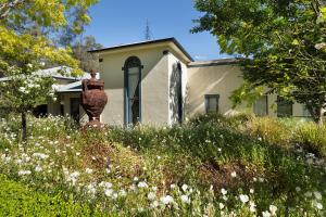 a house with a vase in a field of flowers at Nu Leaf Retreat in Pokolbin